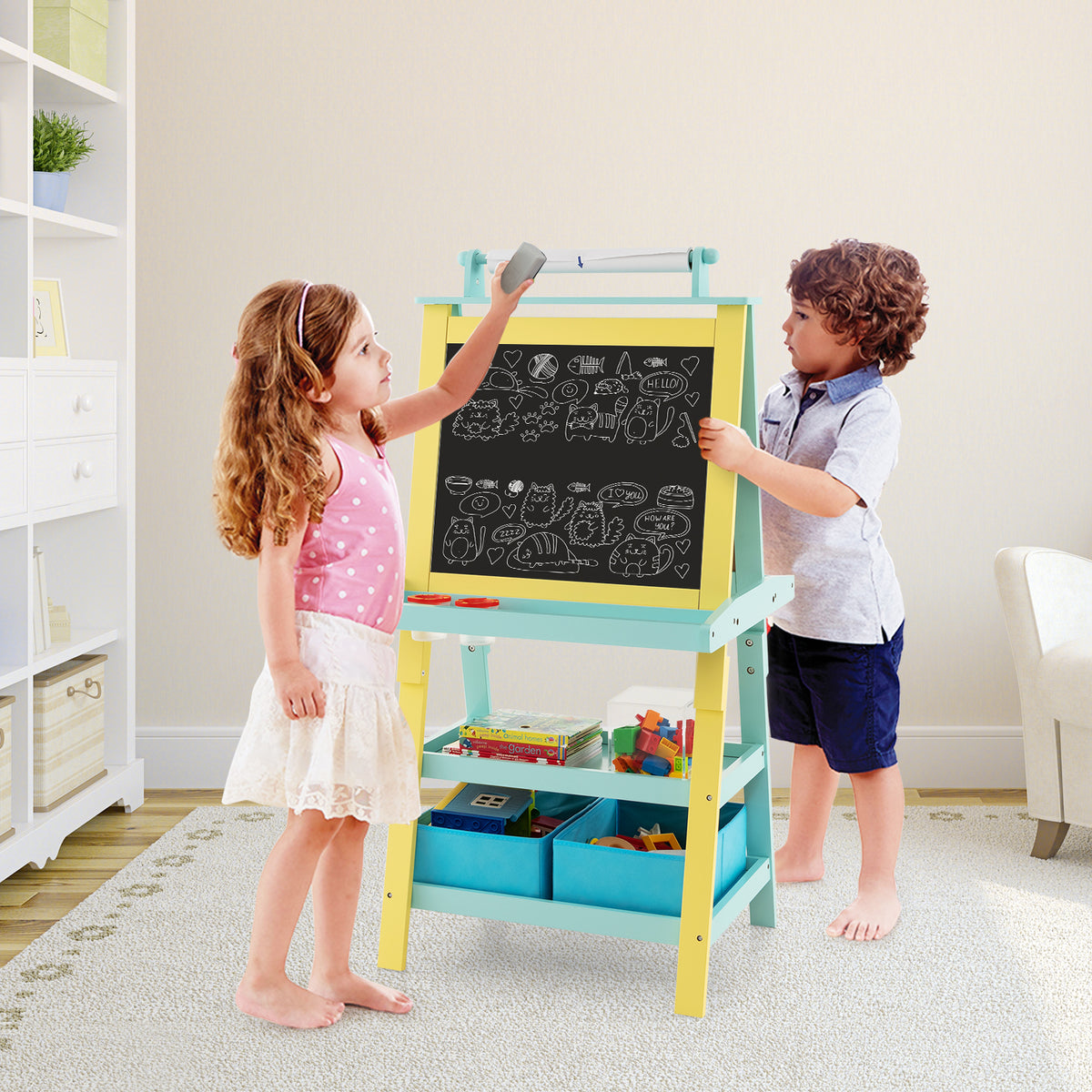 The art easel being used by a young girl and boy in a bright living room setting