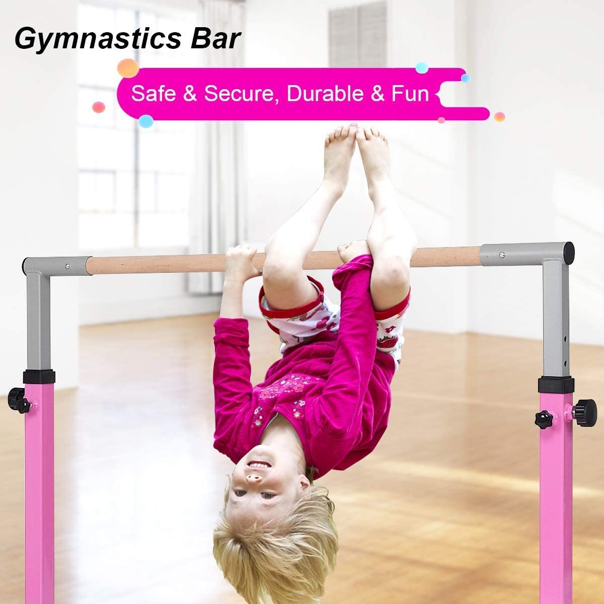 The pink gymnastics bar with a child hanging upside down from the wooden rail