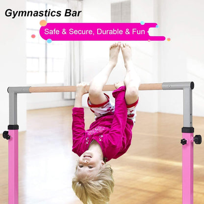 The pink gymnastics bar with a child hanging upside down from the wooden rail