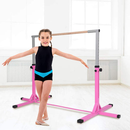 The gymnastics bar standing in a bright room with a young girl posing beside it