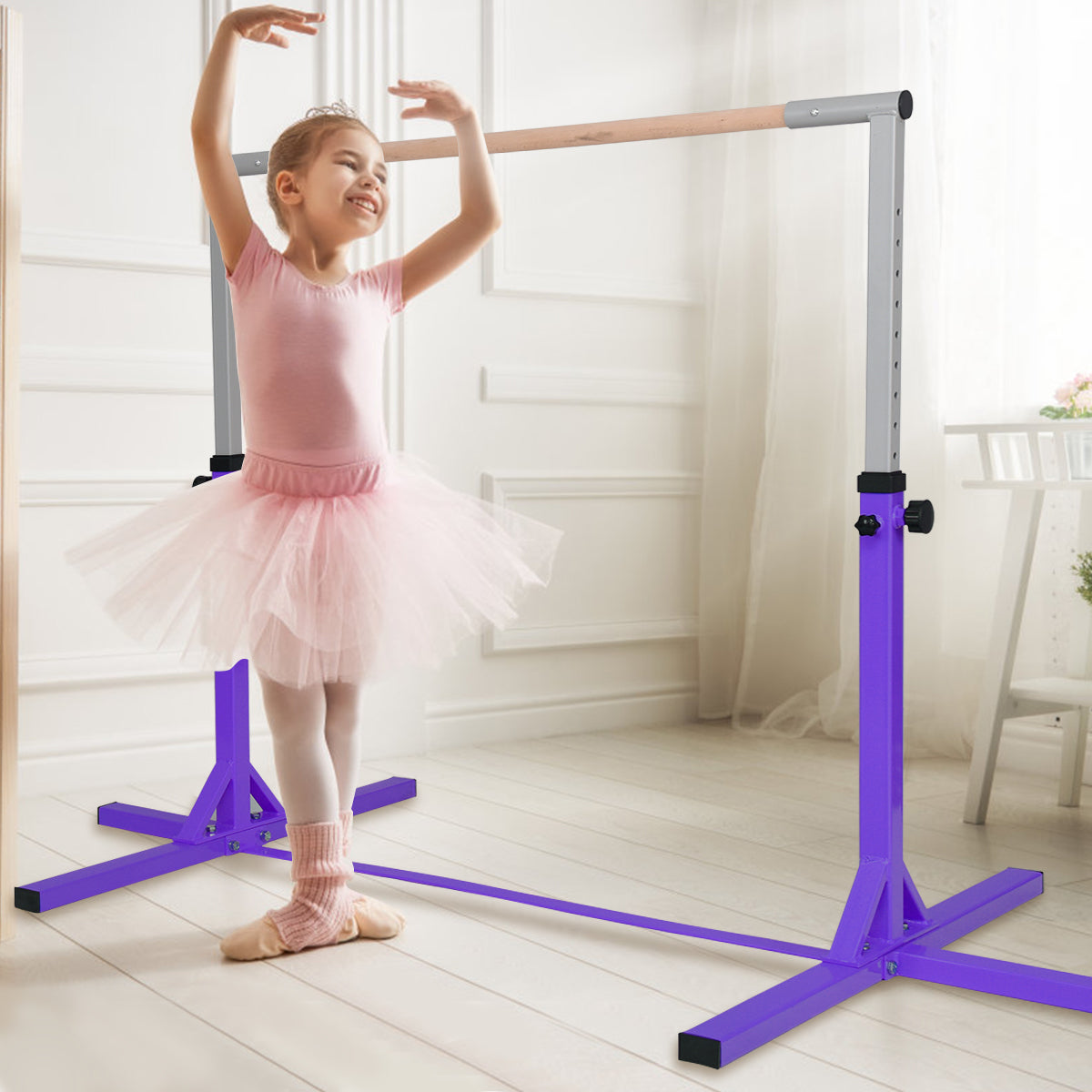 The purple gymnastics training bar with a young girl in a tutu practising ballet