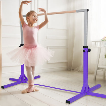 The purple gymnastics training bar with a young girl in a tutu practising ballet