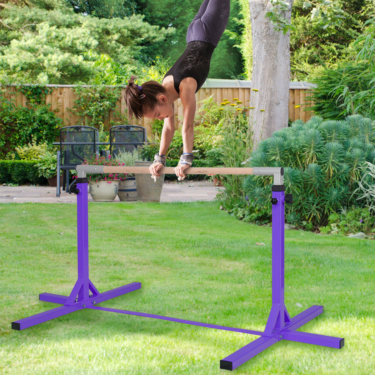 The purple gymnastics training bar in a garden with a girl doing a handstand