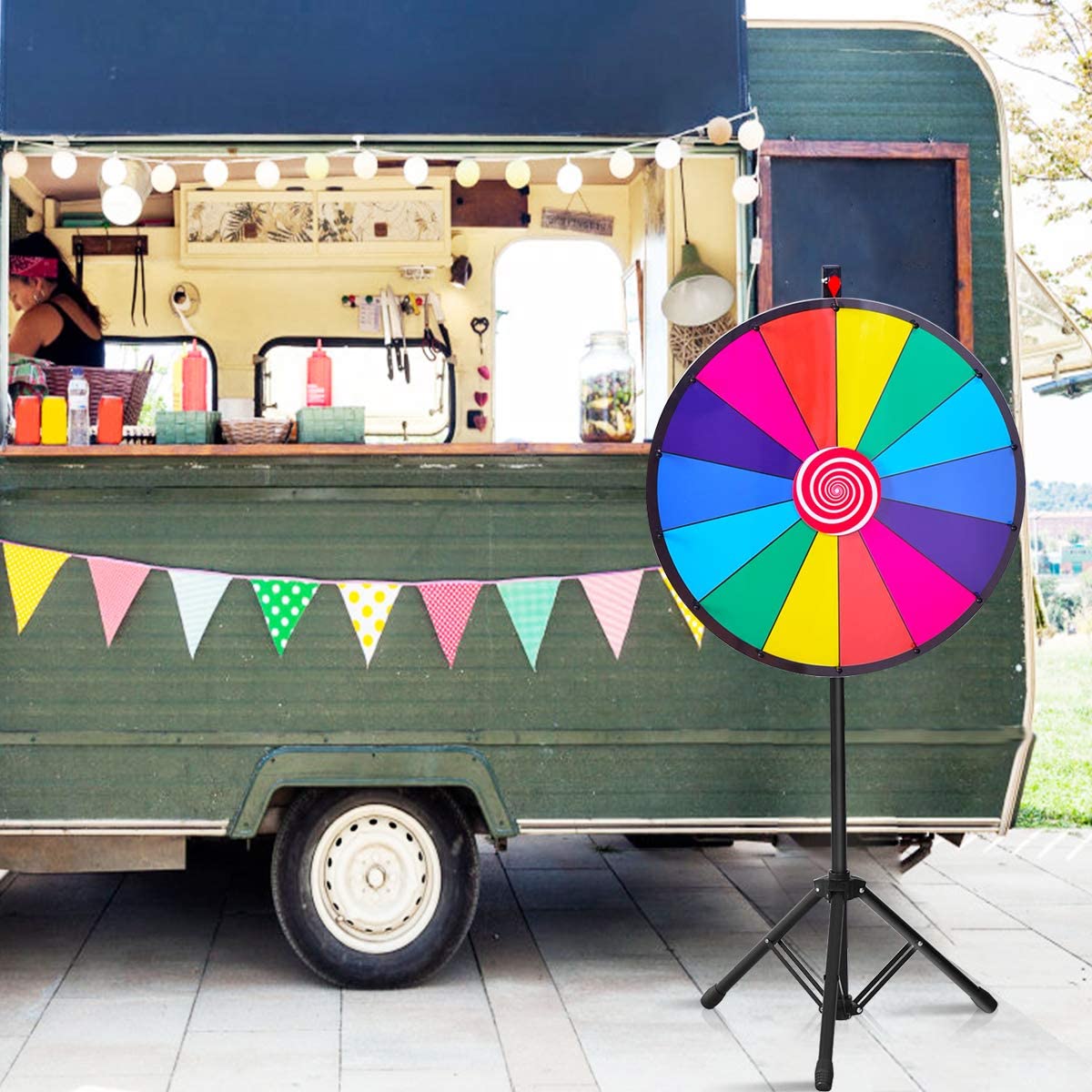 The colourful prize wheel positioned next to a food truck at an event
