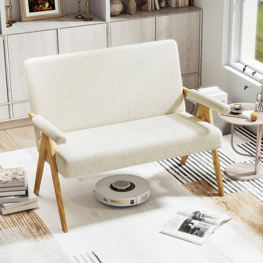 Beige sherpa sofa in a bright living room with a robot vacuum cleaner underneath