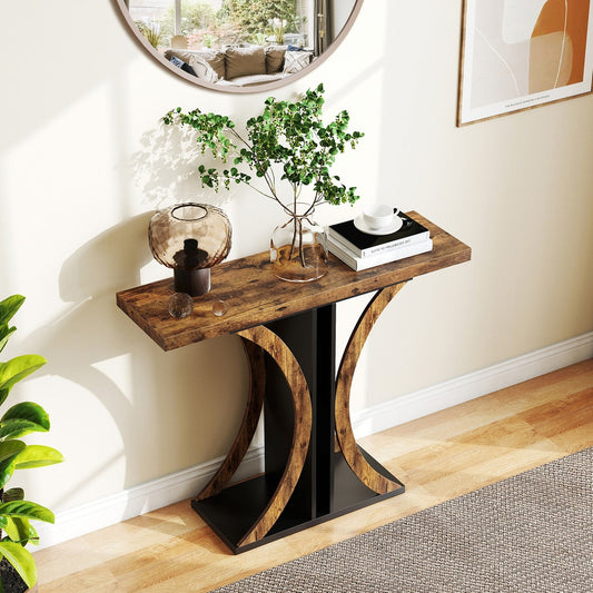 The console table in a hallway with a mirror and plant above it
