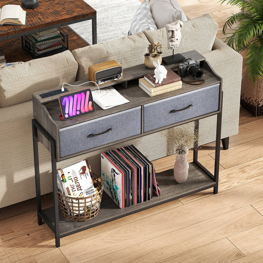 Grey entryway table with two fabric drawers and a lower shelf, styled with books and decor