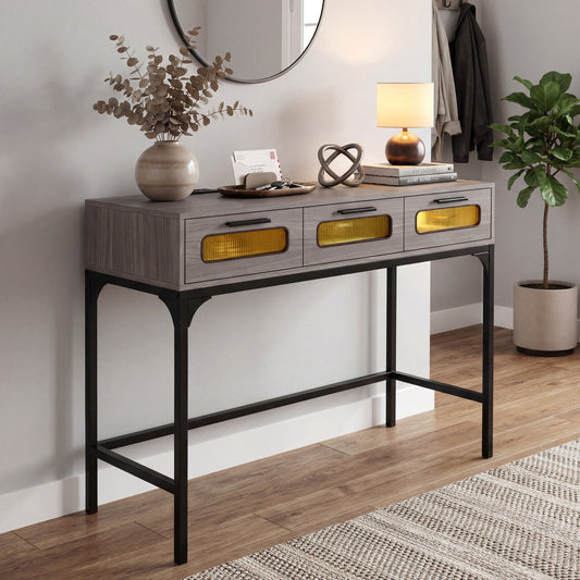 The grey console table with drawers and LED lights is shown in a hallway setting with a mirror and plant
