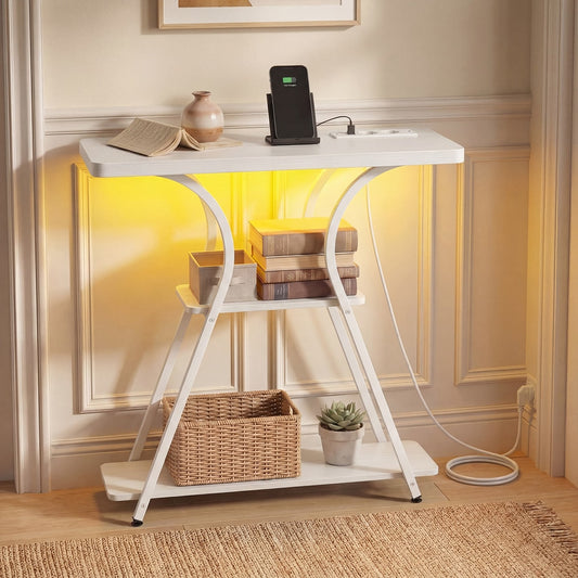 The console table with LED lights on, holding books and a phone charger