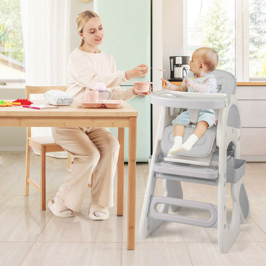 A mother feeding her baby in the grey high chair at a dining table