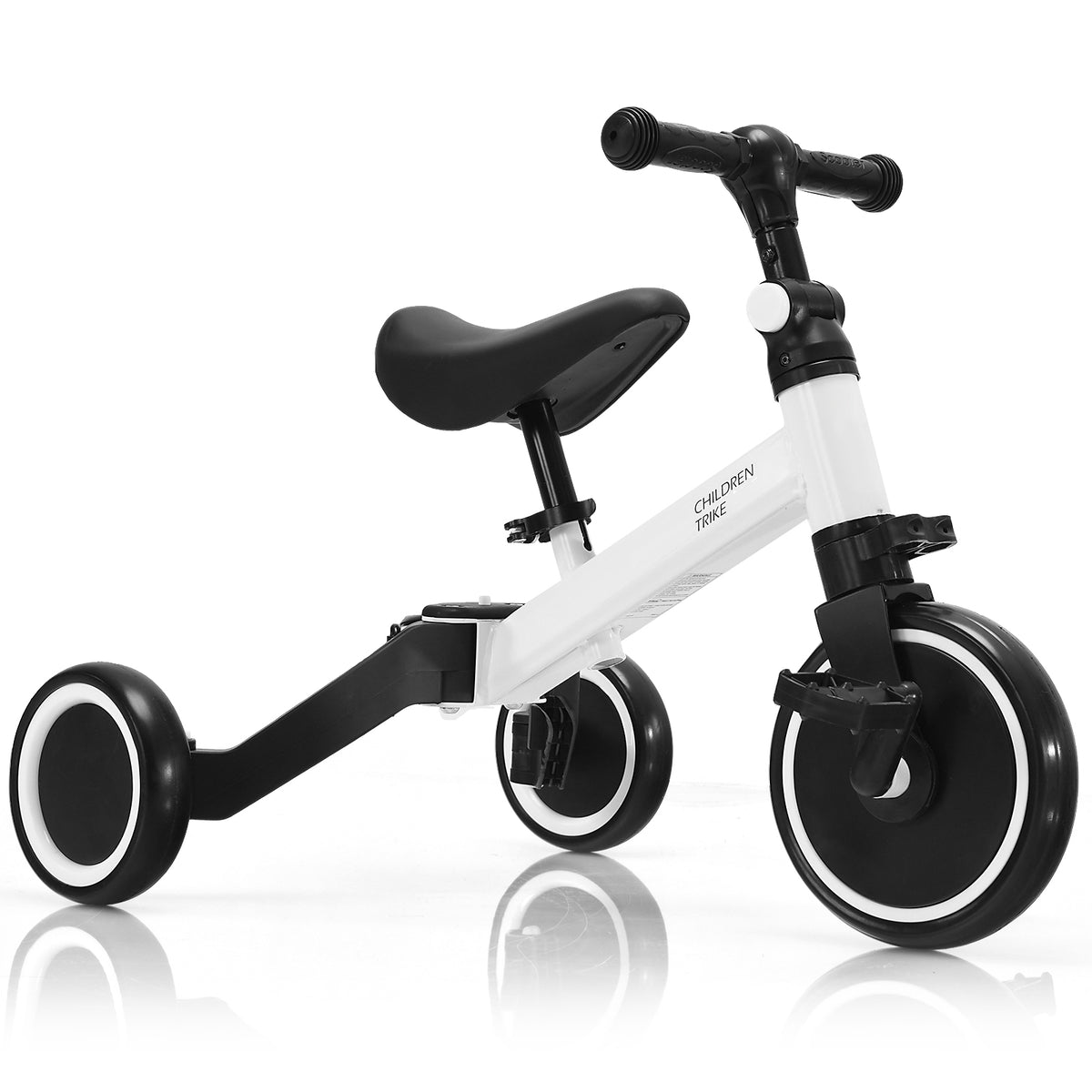 White convertible balance bike with pedals, viewed from the side in a three-wheel configuration