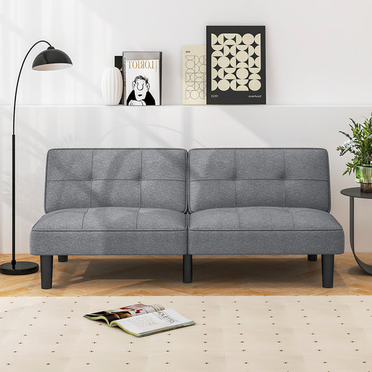 The grey sofa positioned against a white wall in a modern living room setting