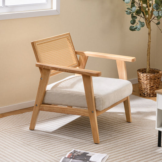 The accent chair angled in a bright room next to a potted plant on a rug