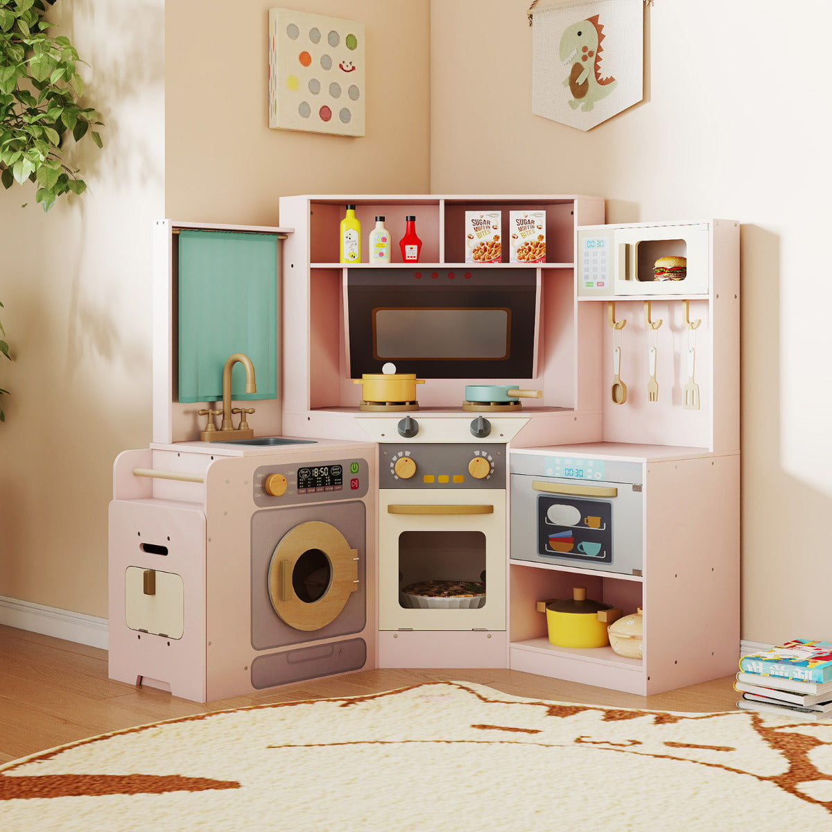 A pink corner play kitchen set with a washing machine, oven, sink and microwave, set up in a room
