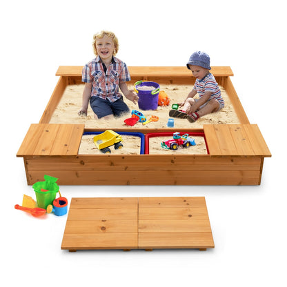 Two smiling children playing with toys in the wooden sandbox with storage boxes