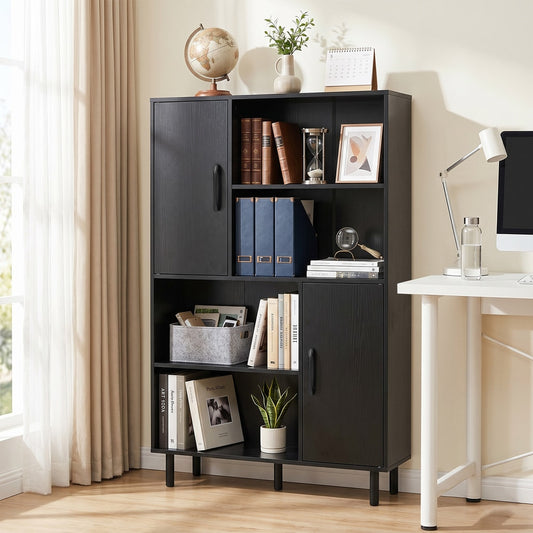 Black storage cabinet with metal legs shown in a home office setting with books and a computer