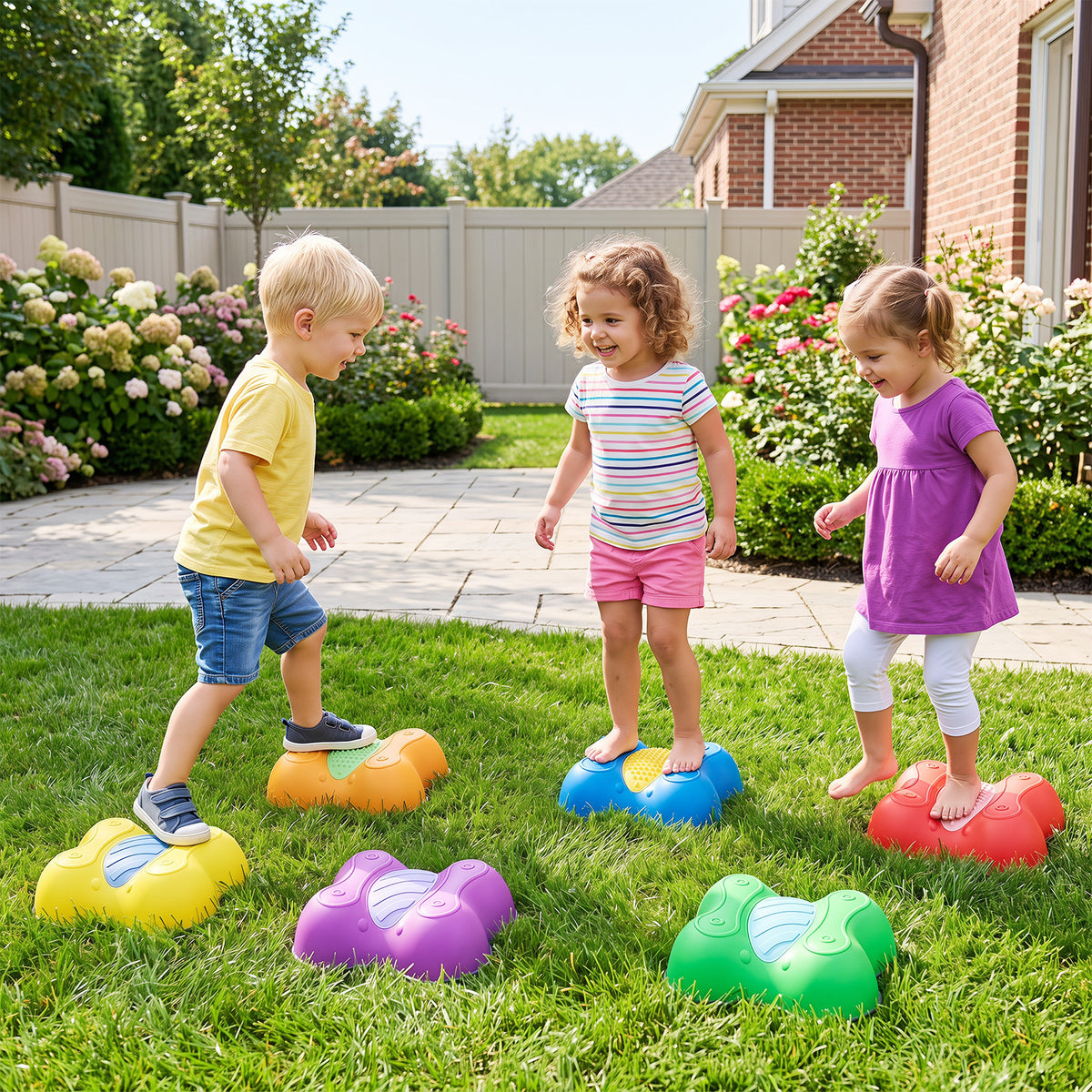 Children playing on the stepping stones in a garden