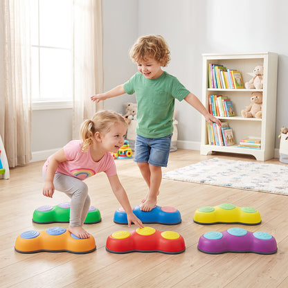 Children balancing on the colourful stepping stones in a bright room