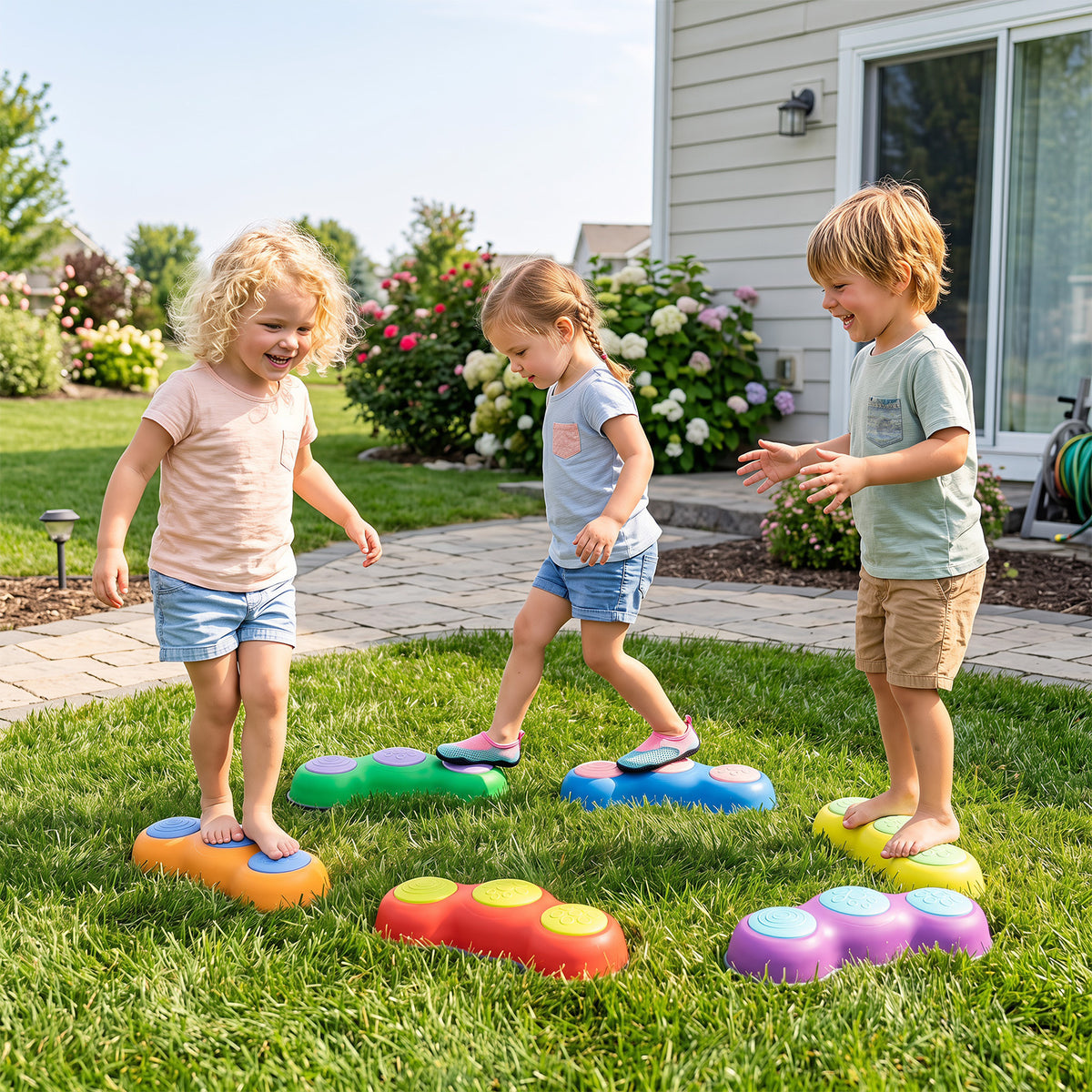 Children playing on the colourful stepping stones in a grassy garden setting