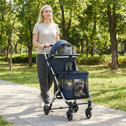 The pet stroller being pushed by a woman along a path in a park with trees in the background