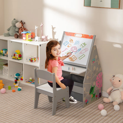 A young girl draws on the whiteboard of the art easel with a chair and storage bins