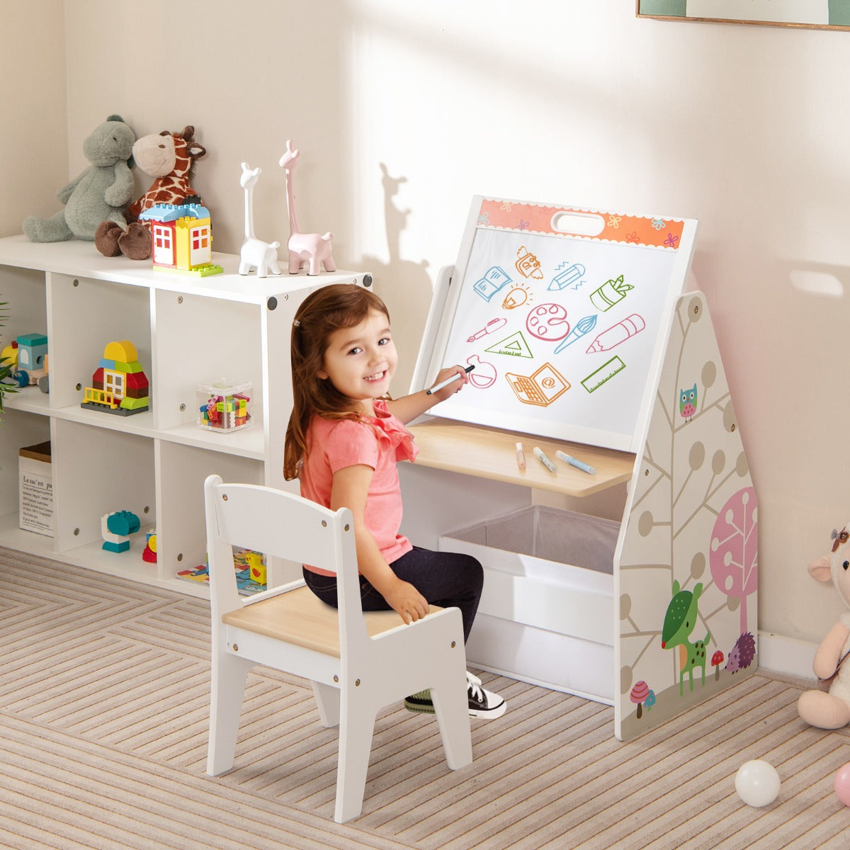 The kids art easel with a whiteboard surface being used by a young girl