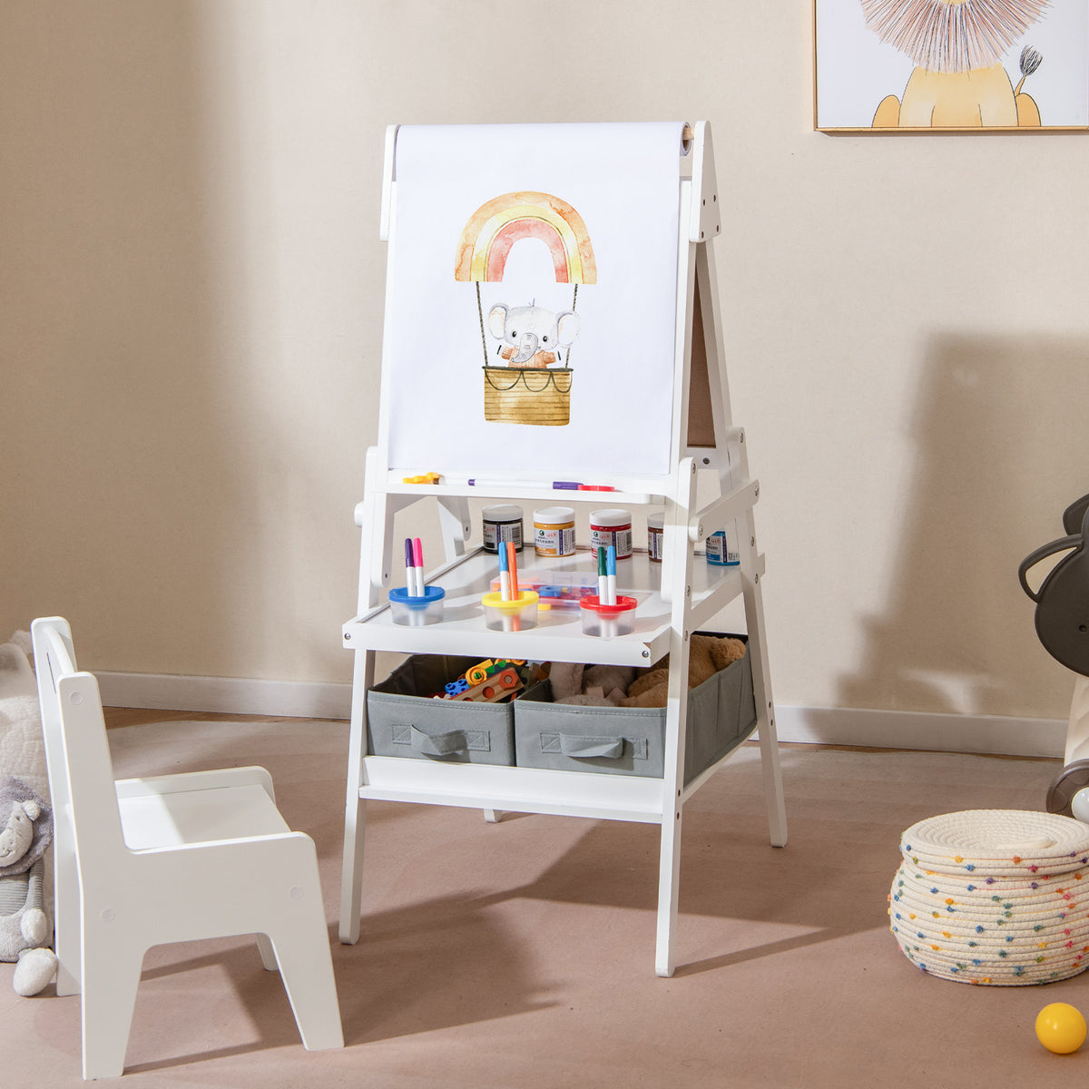 The kids art easel with a drawing of an elephant on a rainbow on the whiteboard side