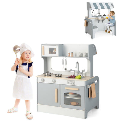 Double Sided Kids Kitchen Playset with Microwave Sink Oven a grey and white wooden toy kitchen with a child playing