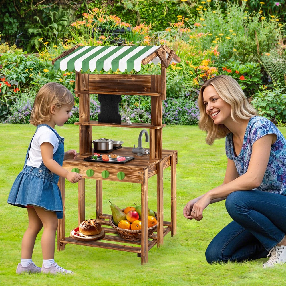 A young girl and an adult woman playing together with the wooden play kitchen