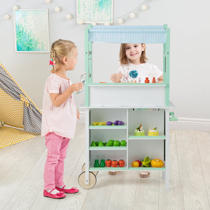 Children interacting with the green and white play kitchen set in a room