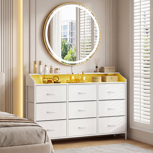 The white dresser with nine drawers is shown in a bedroom setting with a mirror above it