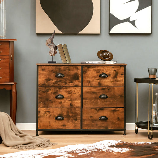 The wooden chest placed in a living room with wall art and a decorative rug on the floor