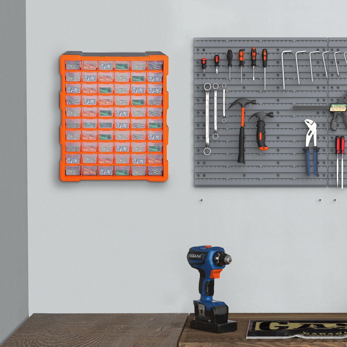 The tool box cabinet on a wall with tools and a drill nearby