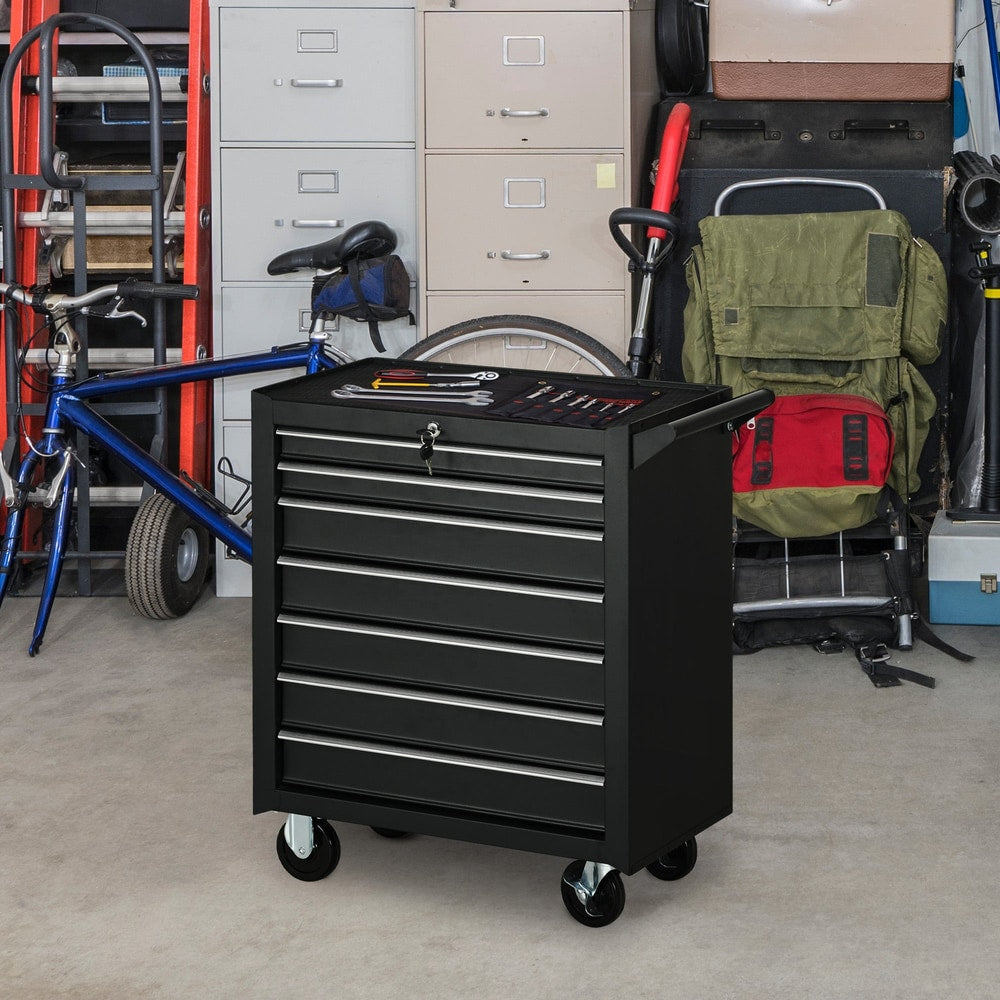 The tool cabinet is shown in a garage setting with a bicycle and storage shelves in the background