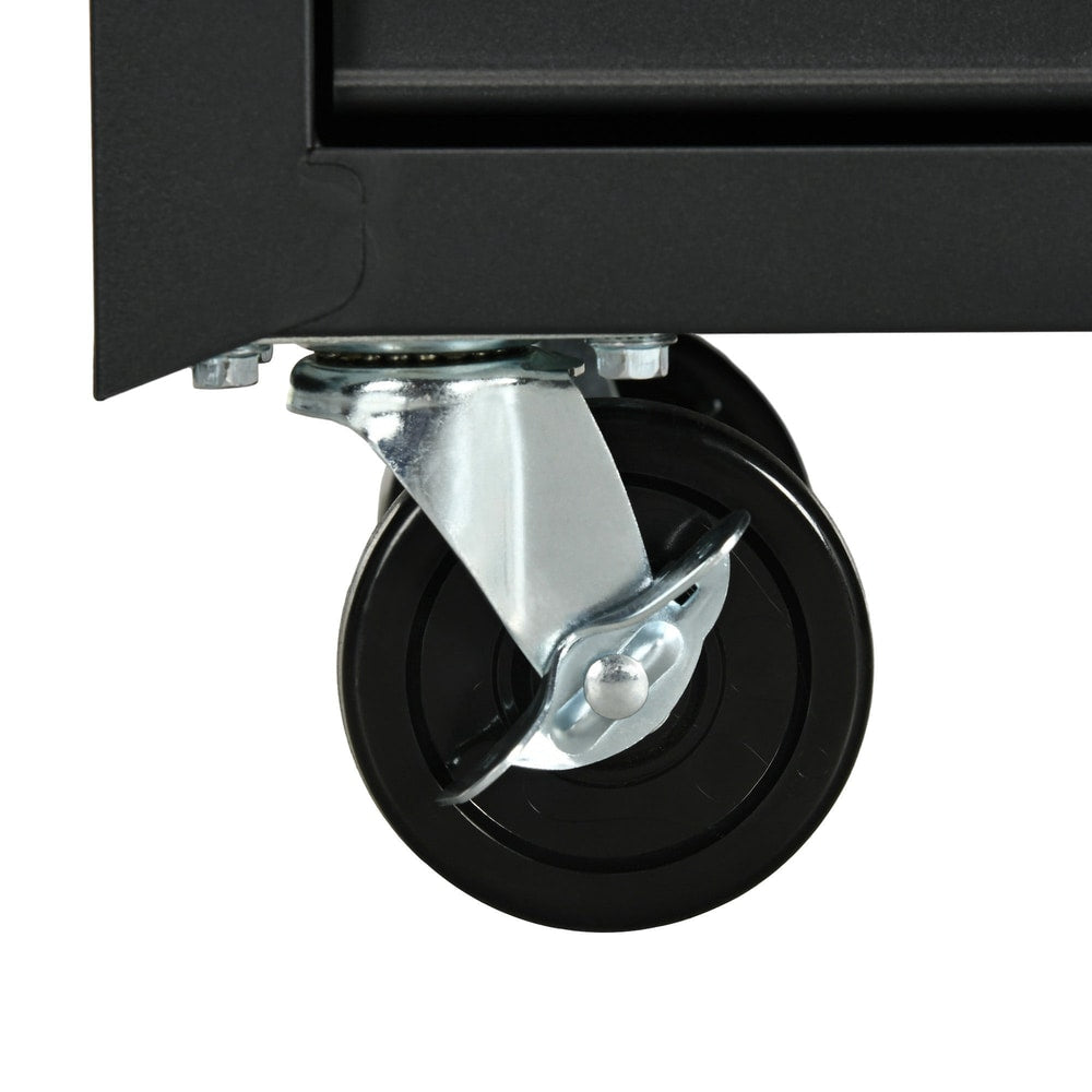 A close-up view of one of the black caster wheels on the tool cabinet