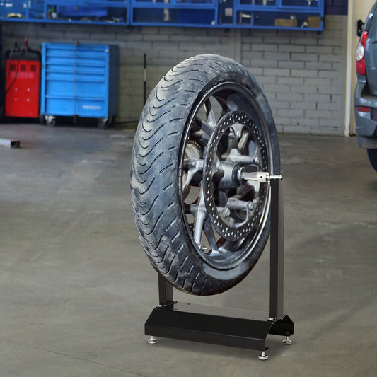 Motorbike portable stand balancing a motorcycle wheel in a workshop setting