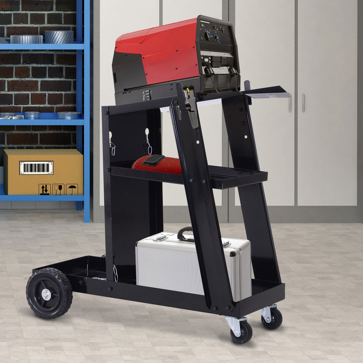 The black metal trolley holds a red welding machine and a silver case on its shelves