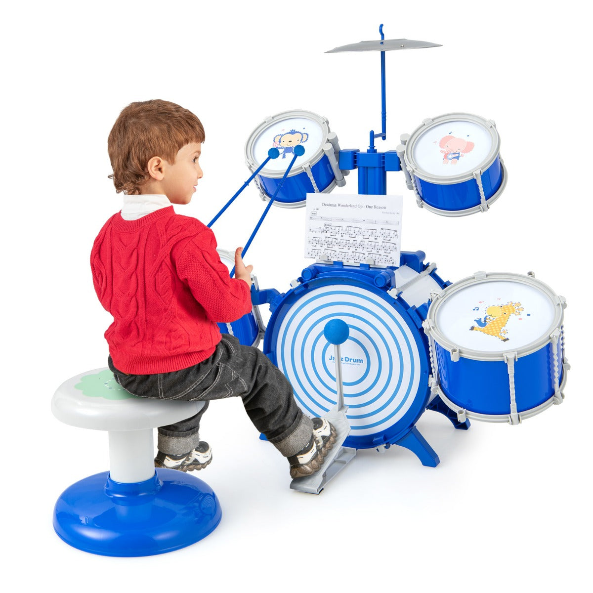 Boy sitting on stool playing the blue drum set with sticks