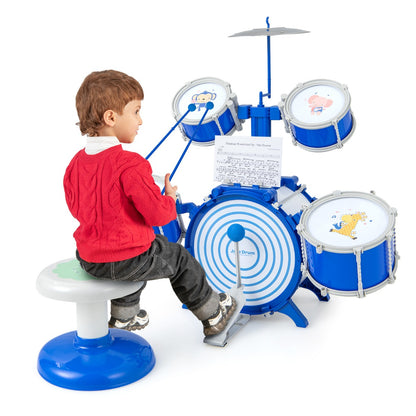 Boy sitting on stool playing the blue drum set with sticks