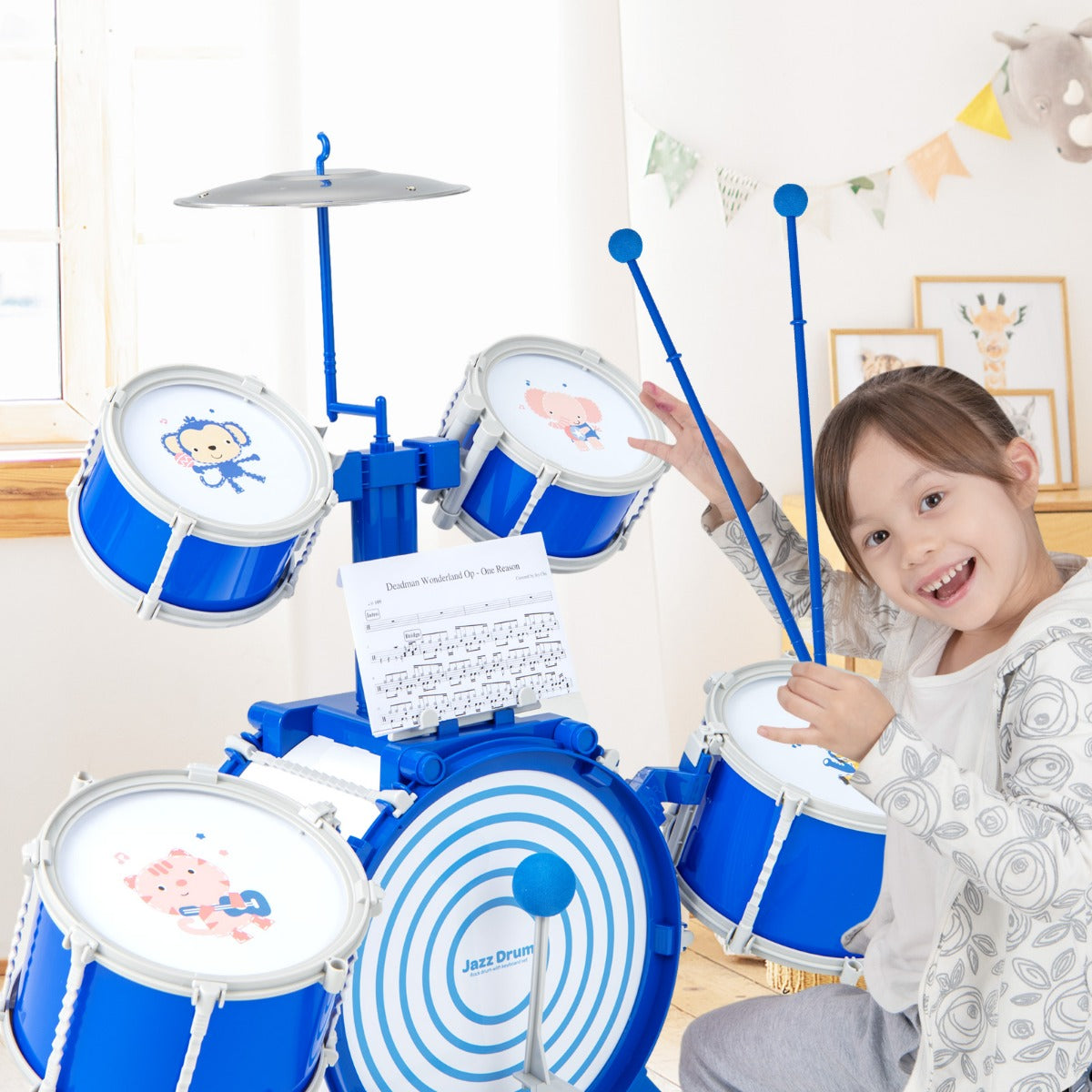 Close up of a girl smiling while playing the blue drum set