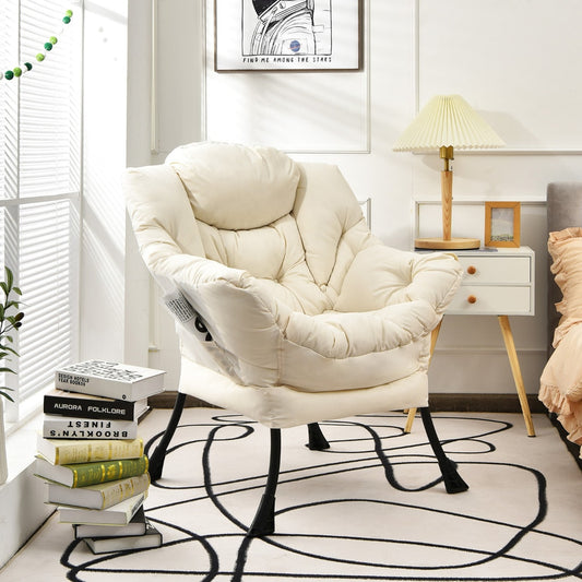 The accent chair is shown in a cosy room setting with books and a lamp nearby