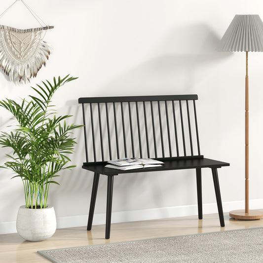 Black spindle back bench in a room with a plant and lamp