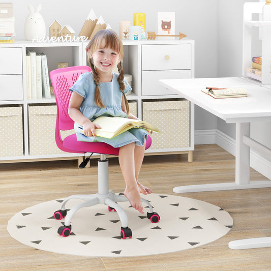 A smiling young girl sits on the pink kids study chair at a desk