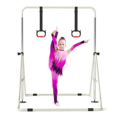 A girl in a sparkly leotard performing a split on the gymnastic bar