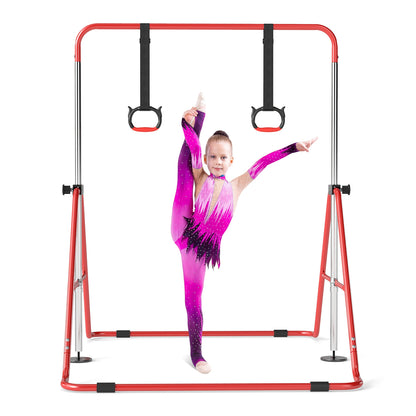 A girl in a sparkly leotard performs a split on the red gymnastics bar