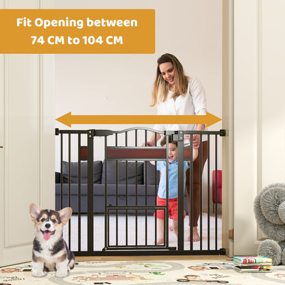 A woman holds a child near the black pet gate which is shown fitted in an opening