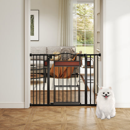 The black pet gate is open in a living room doorway with a white Pomeranian sitting in front