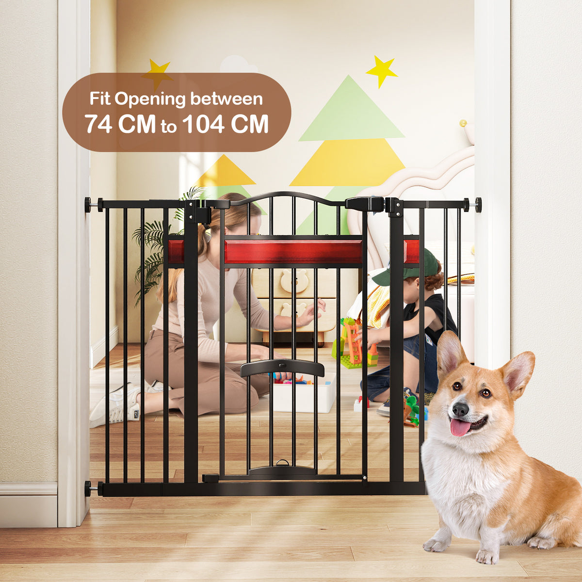 The black pet gate with a small door installed in a room with children playing in the background