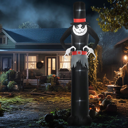 The tall Halloween inflatable ghost is displayed outdoors at night in a garden setting