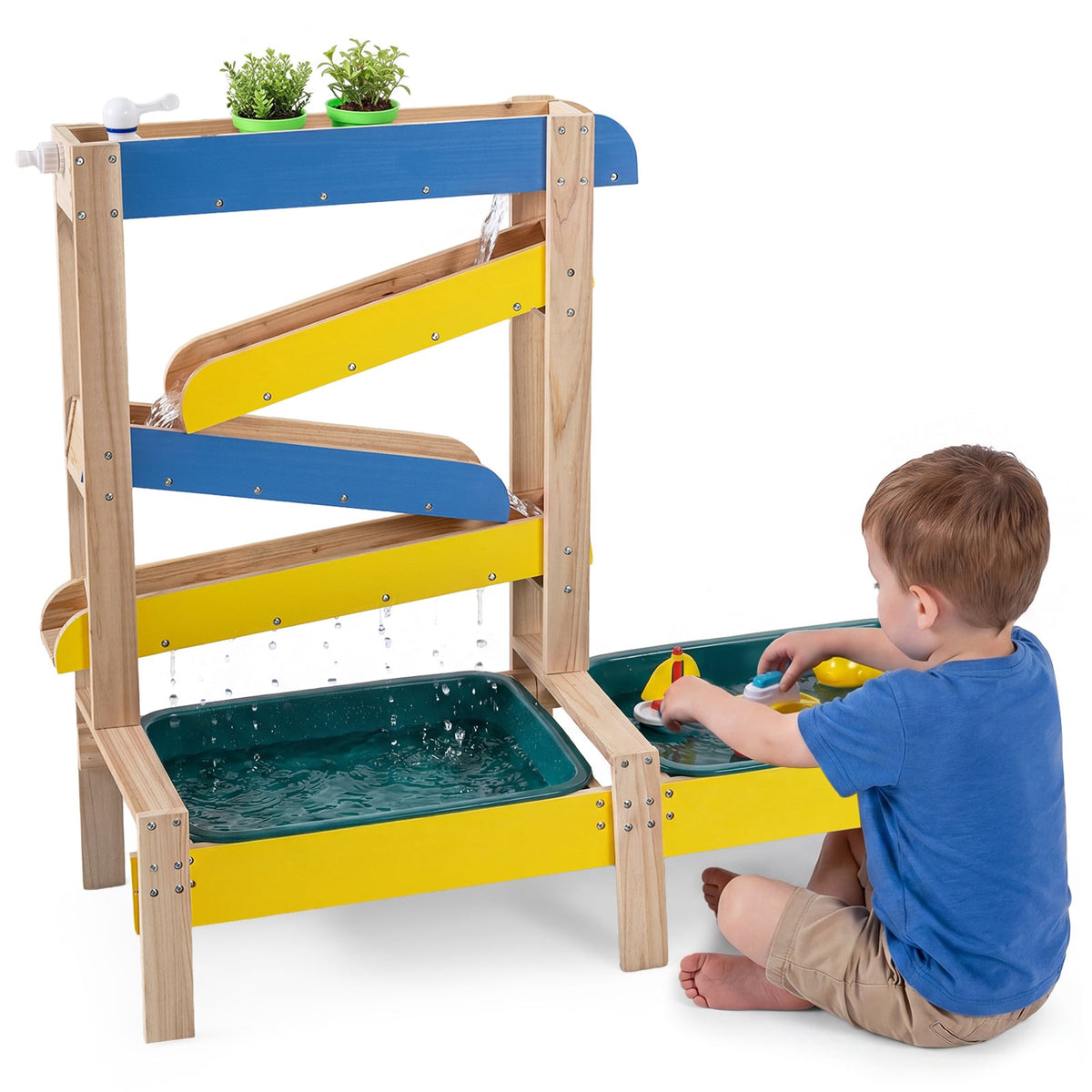 Girl playing with water in the activity table outdoors